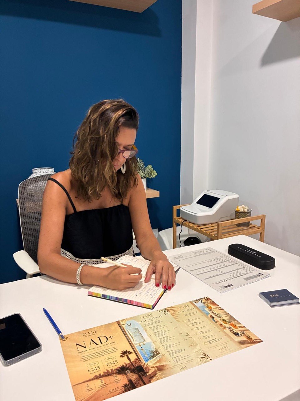 La Dra. Mariana Goldstücker escribe en su libreta durante una valoración, en la consulta de OASE en Alicante
